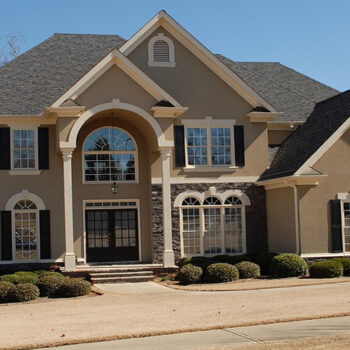 Large suburban house with landscaped front yard.