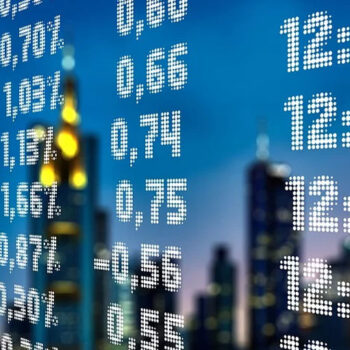 Stock market data over cityscape background.