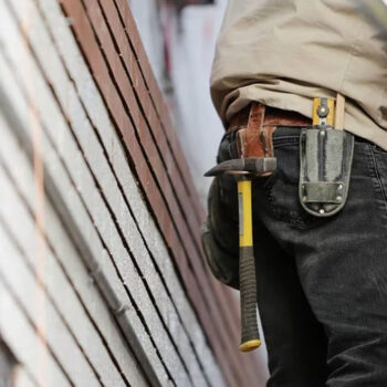 Construction worker with hammer and tool belt.