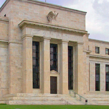 Large stone building with columns and windows.