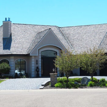 Large house with manicured front lawn.