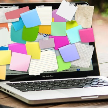 Laptop screen covered with colorful sticky notes.